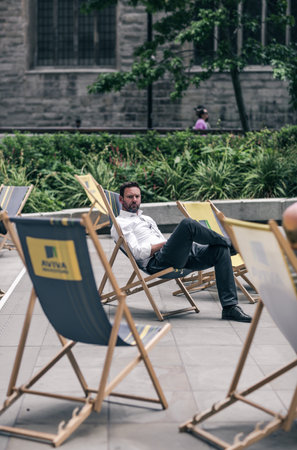 London, UK - June 21, 2022: Young businessman relaxing in the City of London square. City of London financial and business area life, street photographyのeditorial素材