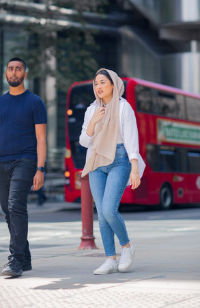 London, UK - 21 June, 2022: Young woman waking on the Thames river walk at summer sunny day.  Street photographyのeditorial素材