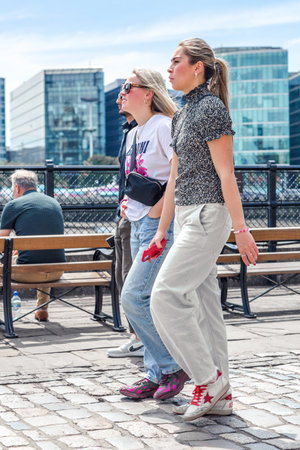 London, UK - 21 June, 2022: Family  waking on the Thames river walk at summer sunny day.  Street photographyのeditorial素材