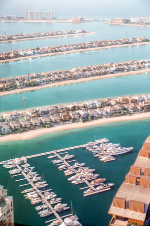 Dubai, UAE - August 28, 2022: Palm Jumeirah yachts pier and holidays villas view at sunsetのeditorial素材