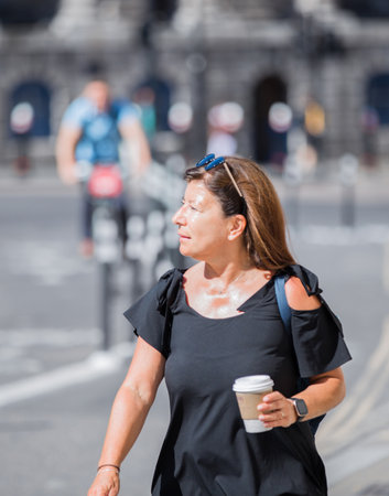 London, UK - June 22, 2022: Young woman rush at work in early morning in the City of London. Business busy life of the City street photographyのeditorial素材
