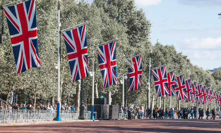 London, UK - September 16, 2022:  The last way of the Queen Elizabeth II. Pall Mall decorated with British flags for funeral ceremony and long queue of people arriving to pay respeのeditorial素材