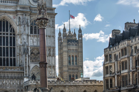 London, UK - September 16, 2022:  Westminster Abbey, Parliament tower with British flag during...