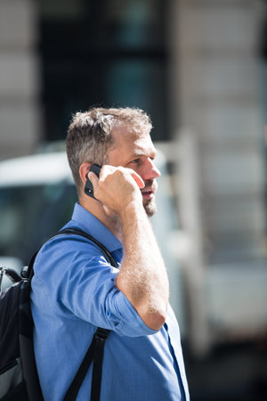 London, UK - June 22, 2022: Businessman is walking in early morning by the Bank of England. Busy business life of the City. People rush at work  street photographyのeditorial素材