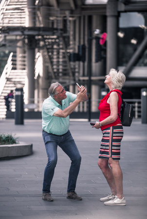 London, UK - June 22, 2022: Couple makes photography in the City of London. Romantic couple, tourists having fun in Londonのeditorial素材