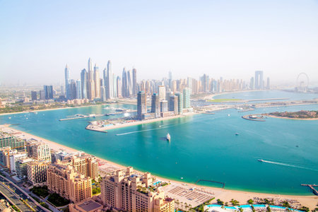 Dubai Marina skyscrapers complex of residential and office buildings at sunset. Yachts and speed boats in the gulf water. Dubai, UAEのeditorial素材