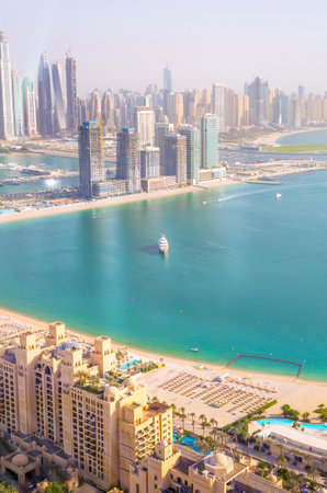Dubai Marina skyscrapers complex of residential and office buildings at sunset. Yachts and speed boats in the gulf water. Dubai, UAEのeditorial素材