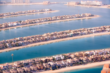 Dubai, UAE - August 28, 2022: Holiday villas at Palm Jumeirah view with beautiful reflection in water. Dubai, UAE.のeditorial素材