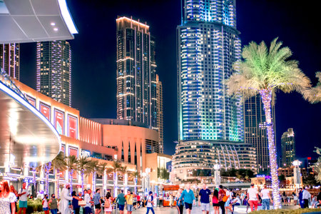 Dubai, UAE - August 28, 2022: Mall square and lots of people walking and waiting for fountains show.のeditorial素材