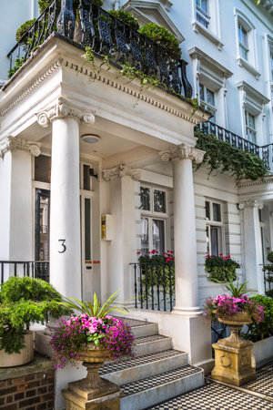 London, UK - 9 September, 2023: Door entrance decorated with flowers in periodic building of Chelsea, one of the richest areas to live with fancy lifestyle. London street photograpのeditorial素材
