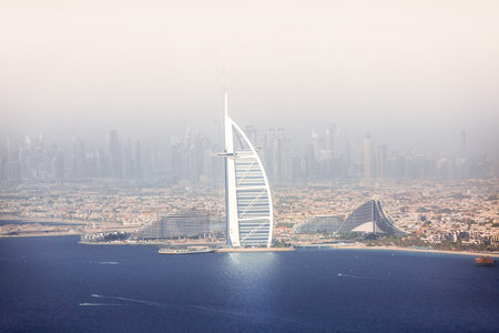 Dubai, UAE - August 28, 2022: Burj Al Arab hotel distant view and Palm Jumeirah with hotels at sunny hot day.のeditorial素材