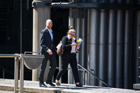London, UK - 7 May, 2024: Business people walking next to Lloyd's building entrance at Lime Street in the City of Londonのeditorial素材