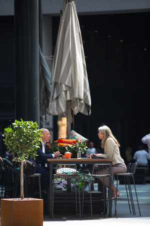 London, UK - 7 May, 2024: Woman sitting in cafe at lunch time n the City of Londonのeditorial素材