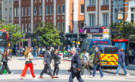 London, UK - 7 May, 2024: City of London Bishop's gate street view with periodic  buildings, double-decker buses and people crossing the roadのeditorial素材