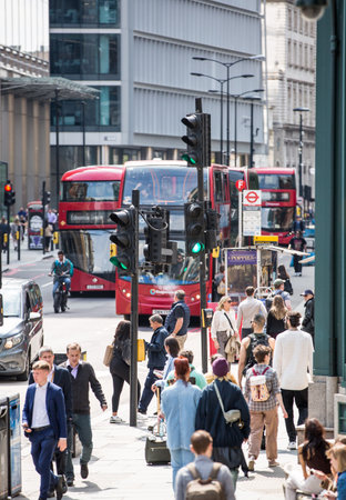 London, UK - 7 May, 2024: City of London, lots of people walking at Bishop's gate street, buses, taxis and cars on the roadのeditorial素材