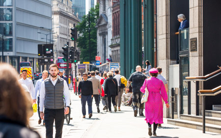 London, UK - 7 May, 2024: City of London, lots of people walking at Bishop's gate street, buses, taxis and cars on the roadのeditorial素材