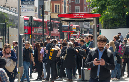 London, UK - 7 May, 2024: Busy bus stop at Bishop's gate street, buses, taxis and cars on the road, people waiting for boardingのeditorial素材