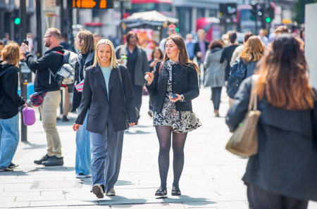 London, UK - 7 May, 2024: City of London, lots of people walking at Bishop's gate street, buses, taxis and cars on the roadのeditorial素材