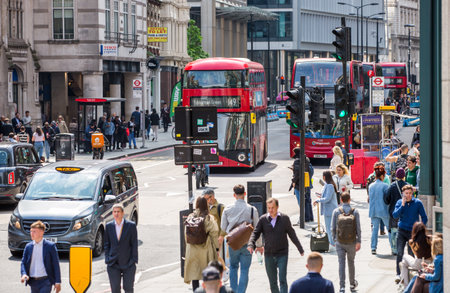 London, UK - 7 May, 2024: Busy bus stop at Bishop's gate street, buses, taxis and cars on the road, people waiting for boardingのeditorial素材