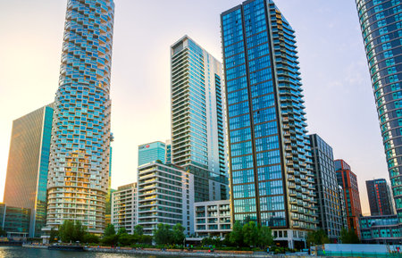London, UK - June 14, 2025: South dock in Canary Wharf at sunset. New residential developmentのeditorial素材