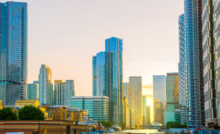 London, UK - June 14, 2025: Beautiful sunset in docklands. Canary Wharf middle dock skyscrapers,...
