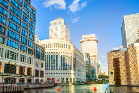 London, UK - June 14, 2025: South dock in Canary Wharf at sunset. New residential developmentのeditorial素材