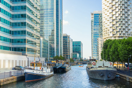 London, UK - June 14, 2025: South dock in Canary Wharf at sunset. New residential development