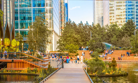 London, UK - 14 June, 2025: Eden dock view with corporate buildings in Canary Wharf at sunset.のeditorial素材