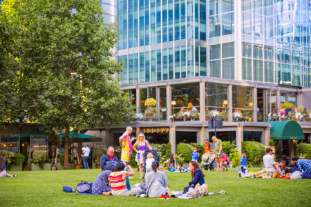 London, UK - 18 June, 2025: Lots of people walking in Greenwich square at sunset.のeditorial素材