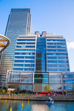 London, UK - 14 June, 2025: Eden dock view with corporate buildings in Canary Wharf at sunset.