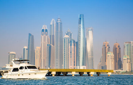 Dubai, UAE - 26 August, 2024: Marina beach with long line of hotels and residential skyscrapers....