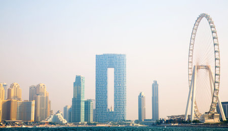 Dubai, UAE - 26 August, 2024: Marina beach with long line of hotels and residential skyscrapers. Panoramic view from boatのeditorial素材