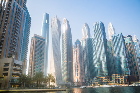 Dubai, UAE - 26 August, 2024: Marina beach with long line of hotels and residential skyscrapers....
