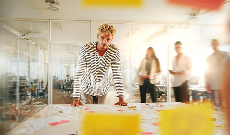 A vibrant startup team working together in a office environment, reflecting innovation, creativity, and a dynamic modern work culture.の素材