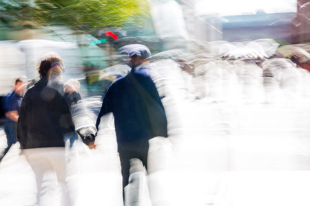 Artistic motion of people walking, crossing junction at sunny day.
