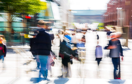 Artistic motion of people walking, crossing junction at sunny day.の写真素材