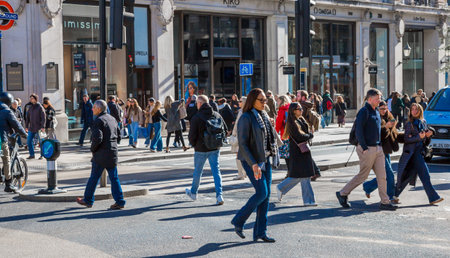 London, UK - October 24, 2025: Crowd of people, shoppers and tourists crossing Walking on Regent street