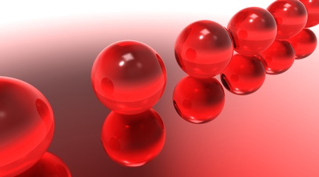 Balls glass red on a reflecting surfaceの写真素材