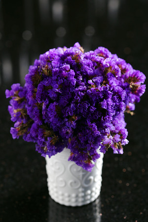 Purple Statice Flowers in white jar and selective focus with Bokeh backgroundの写真素材
