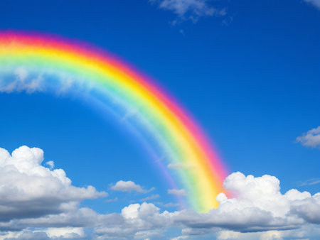 Rainbow in the blue sky with white clouds and blue sky backgroundの素材