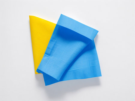 Blue and yellow napkin isolated on white background. Top view.の素材