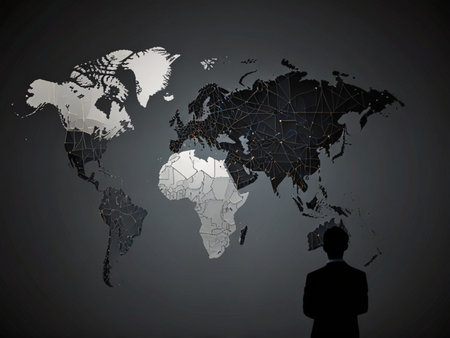 Silhouette of businessman looking at world map on gray background.の写真素材