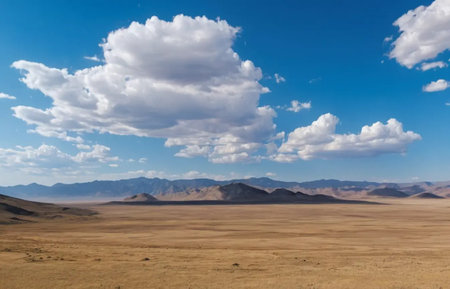 Mongolian desert landscape under blue sky with white clouds.