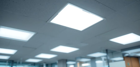 White ceiling light on empty office building. Blurred abstract background.の写真素材