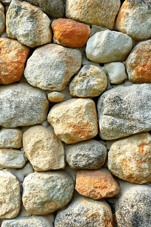 Texture, background. The stone wall is lined with different stones.の写真素材