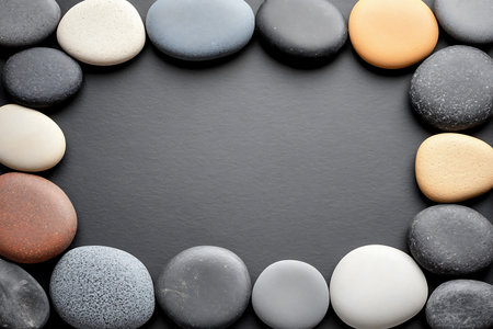 Black and white pebbles on black background with copy space.の写真素材