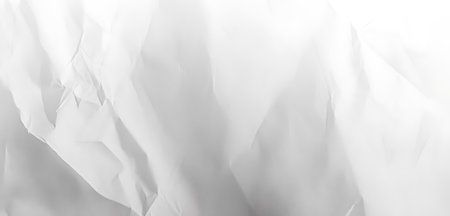 Monochromatic image of crumpled paper, featuring soft gradients and subtle textures. The abstract pattern is formed by the wrinkles and folds, creating a delicate and artistic design element.の写真素材