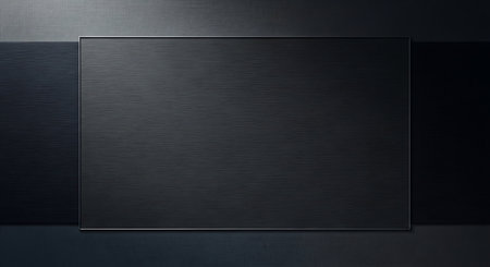 Black metal plate on a dark background. Place for your text.の写真素材