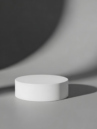 3d rendering of white round podium on gray background with shadow.の写真素材