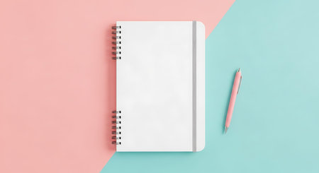 An organized pastel workspace with a notebook and pen.の写真素材